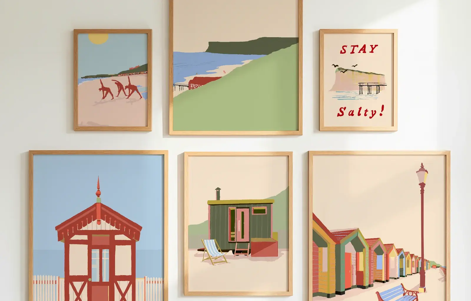 Six Pikku Prints framed in oak and hung as a grid on a white wall
