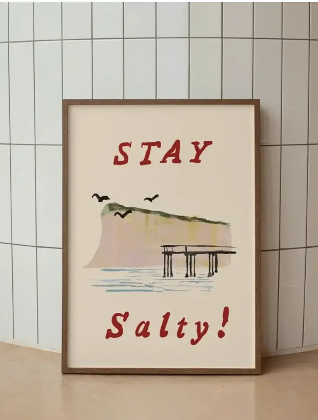 Stay Salty! framed in dark oak against green tiles